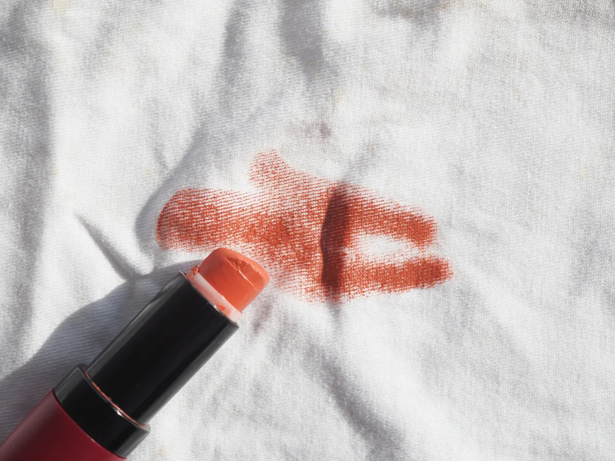 Red lipstick stain on the collar of a white shirt